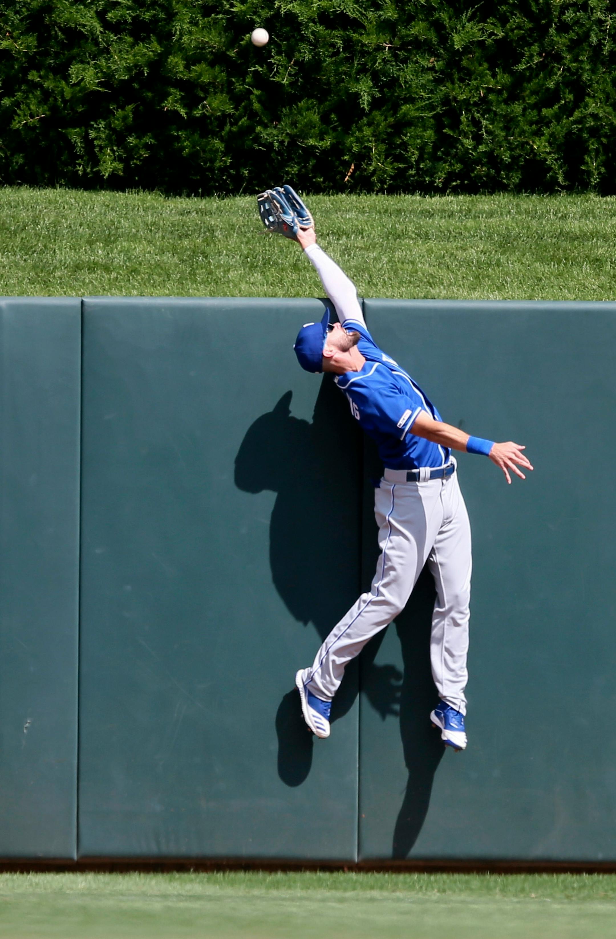 Kansas City Royals center fielder Bubba Starling goes up the wall to no avail on a home run by Minnesota Twins' Jason Castro in the seventh inning of a baseball game Sunday, Aug. 4, 2019, in Minneapolis. (AP Photo/Jim Mone)