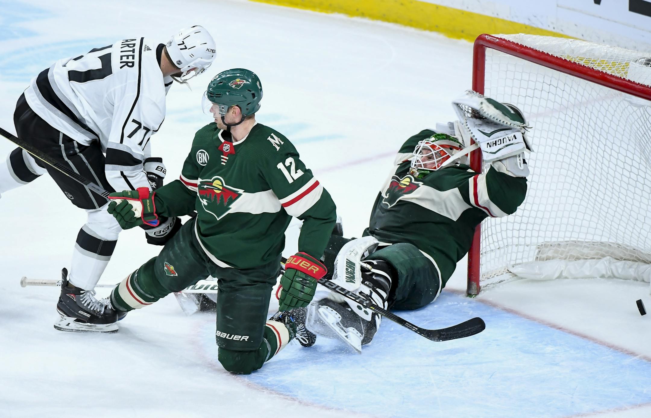Minnesota Wild goaltender Alex Stalock (32) fell into the goal post as Los Angeles Kings center Jeff Carter (77) scored the game-tying goal late in the third period Tuesday, forcing overtime.