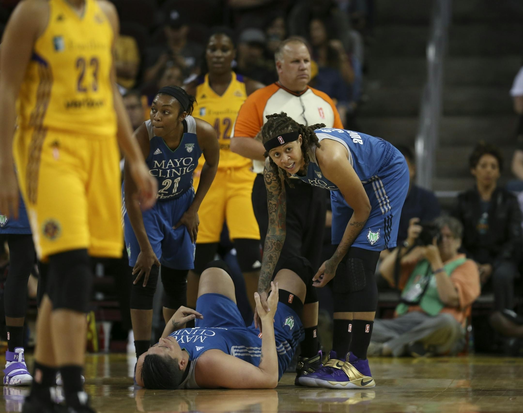 Minnesota Lynx guard Seimone Augustus (33) held the hand of Lynx center Janel McCarville (4) after she was injured in the third quarter.