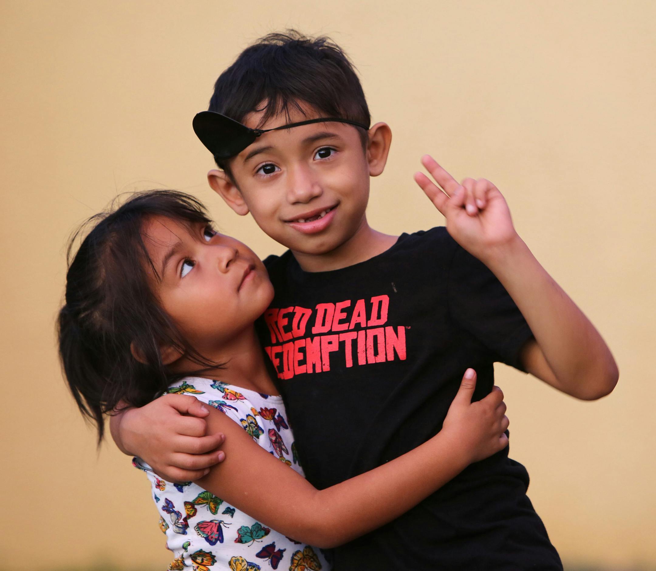 Isabella Morales, 4, hugs her brother and best friend, 7-year-old Julian Morales, outside of their Homestead, Fla. home on Wednesday evening, Sept. 26, 2018. Julian has a very rare genetic disorder and is in need of a lifesaving bone marrow transplant. (Emily Michot/Miami Herald/TNS)