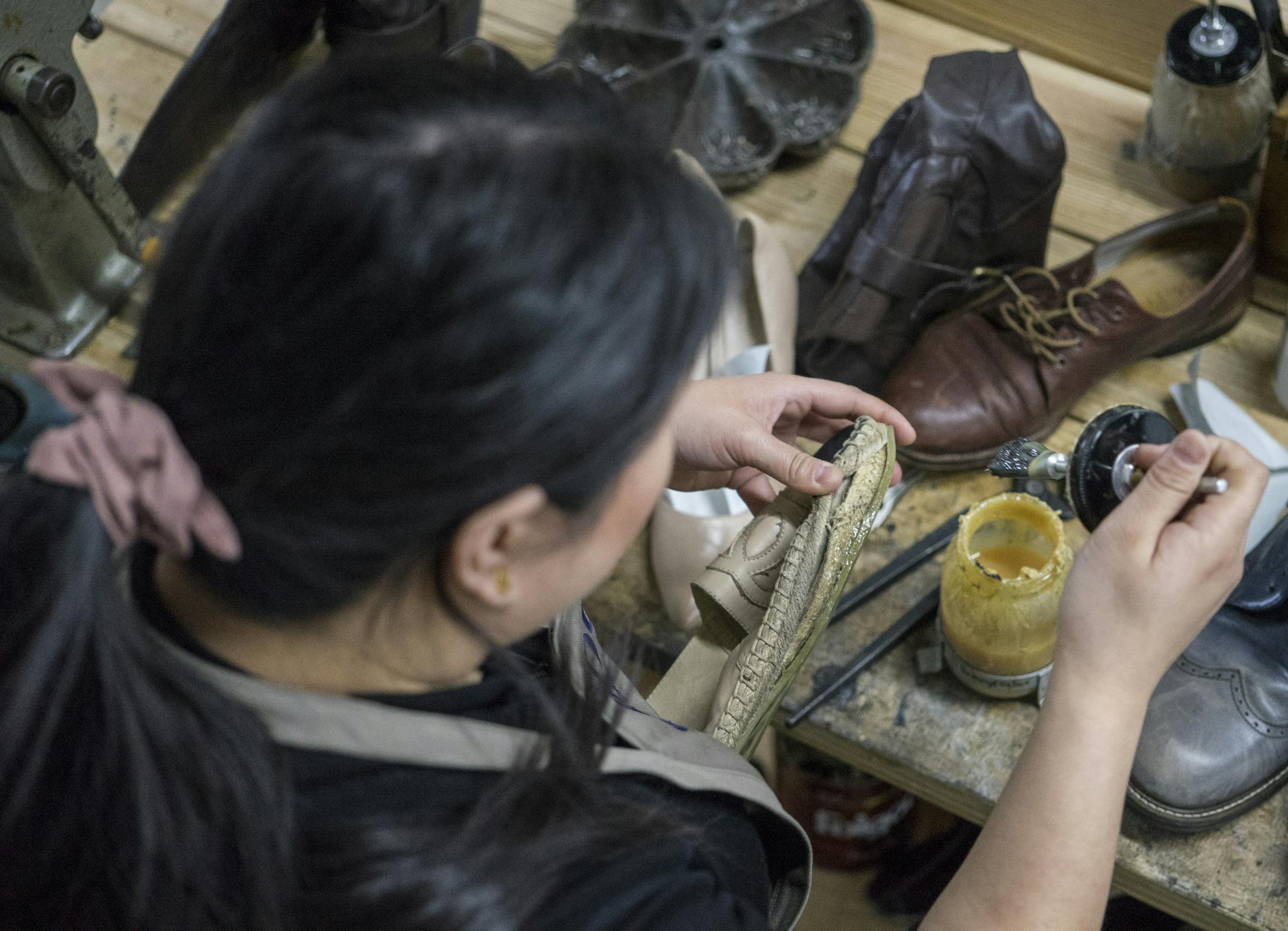 Shooli partner Meghan Flynn glues the bottom of a Chanel shoe at the repair shop in Minneapolis using barge glue.]
TONY SAUNDERS ° anthony.saunders@startribune.com on Friday, April 12, 2019. Shooli is a startup door-to-door shoe shine and repair service in Minneapolis, Minn.