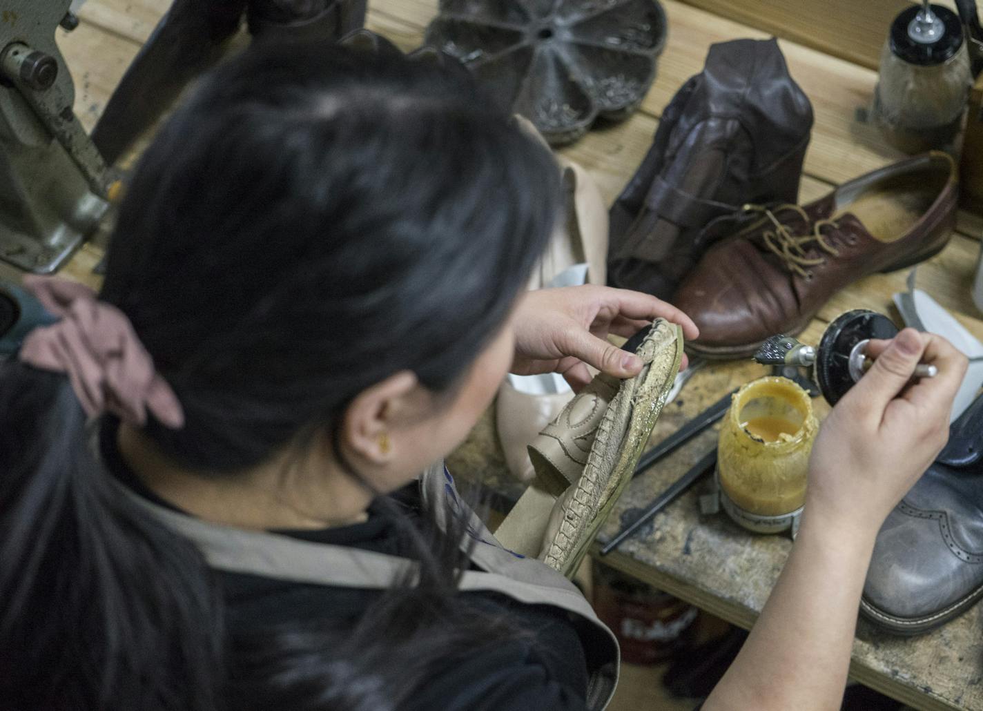 Shooli partner Meghan Flynn glues the bottom of a Chanel shoe at the repair shop in Minneapolis using barge glue.]
TONY SAUNDERS &#xb0; anthony.saunders@startribune.com on Friday, April 12, 2019. Shooli is a startup door-to-door shoe shine and repair service in Minneapolis, Minn.