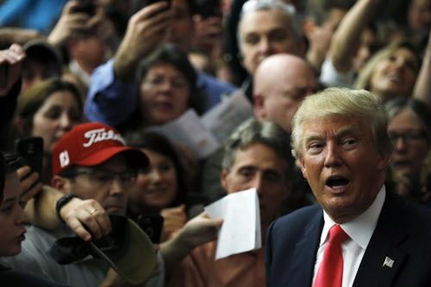 Republican presidential candidate Donald Trump meets with attendees during a campaign stop Tuesday, Feb. 2, 2016, in Milford, N.H.