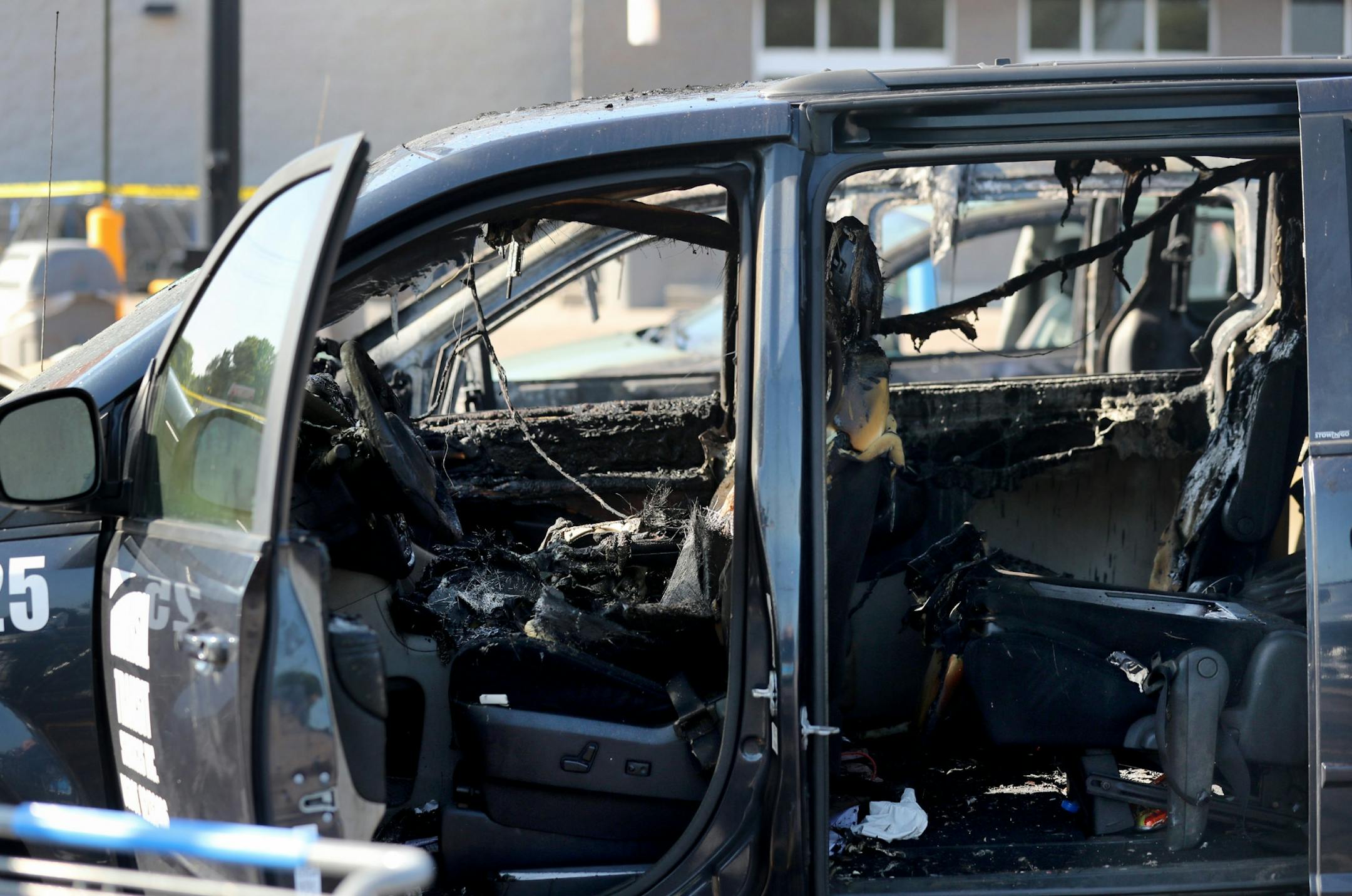 A car fire at a Fridley Walmart engulfed three vehicles and left two young passengers injured in a taxi van parked next to the vehicle where the fire originated Tuesday, Aug. 6, 2019, in Fridley, MN. Here, the burned out interior of the vehicle where two children were injured in the fire.