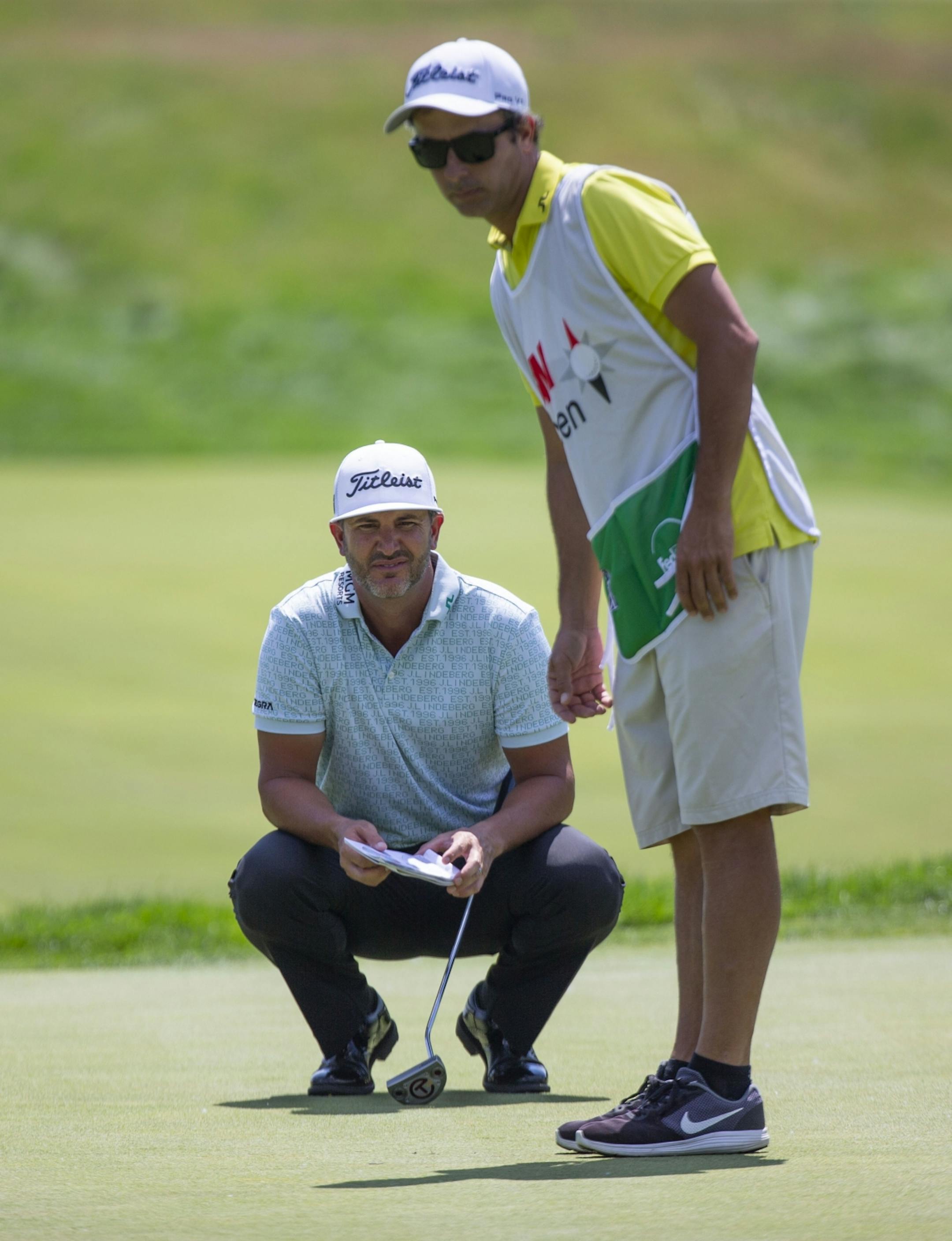 Scott Piercy and his caddy assess the pitch of the first green. ALEX KORMANN ¥ alex.kormann@startribune.com Competitors for the 3M Open took to the course on Saturday.