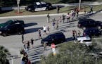 Students held their hands in the air as they were evacuated by police from Marjory Stoneman Douglas High School in Parkland, Fla., after a shooter ope