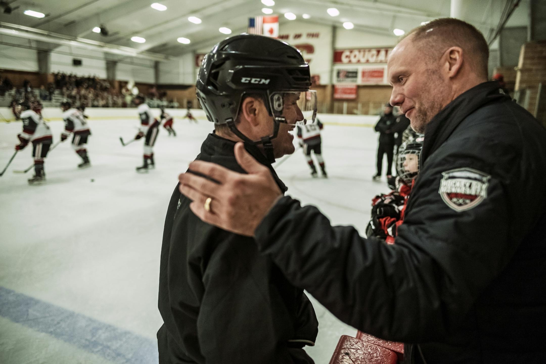 C.J. Beaurline greets Centennial's head coach Ritch Menne before the game against Duluth East. Beaurline has over 20 years of experience as an official. He also works Gophers' hockey games on the weekend.