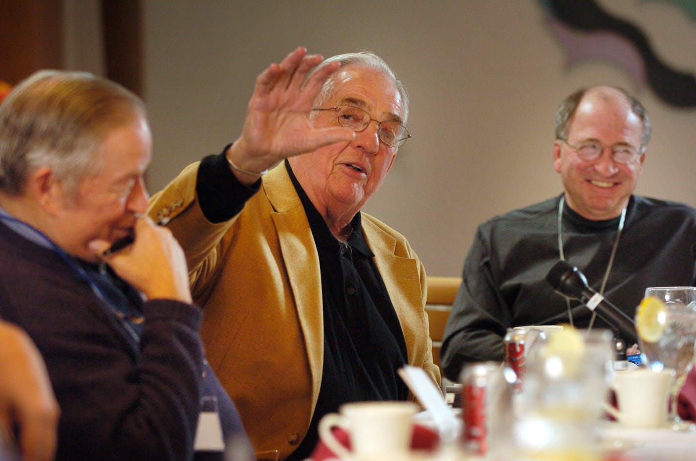 Glen Sonmor (center) with Williard Ikola (left) and Doug Woog (right).