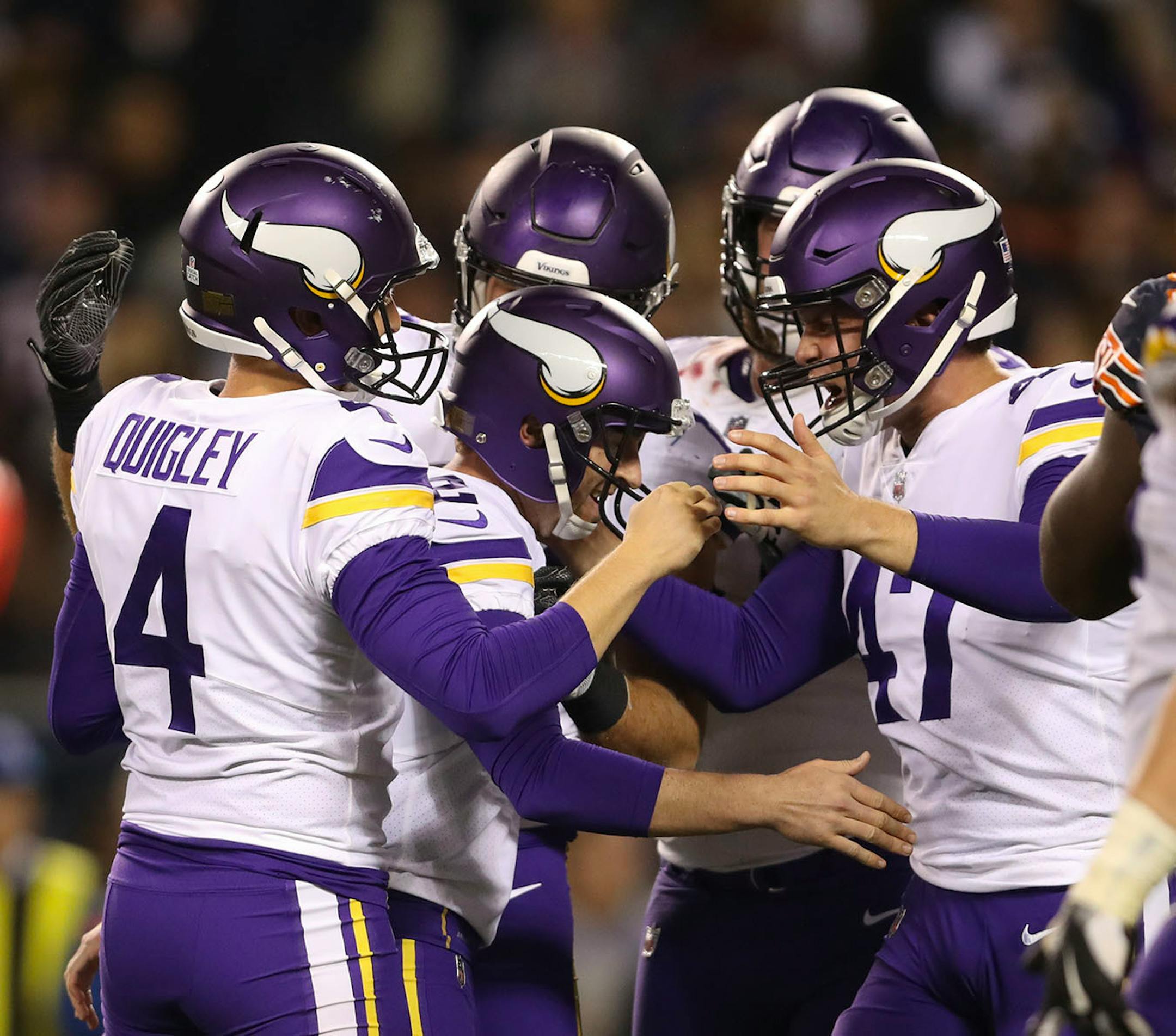Teammates congratulate Vikings' kicker Kai Forbath after he hit a 26 yard field goal with 16 seconds left on the clock to lift the Vikings over the Bears 20-17.