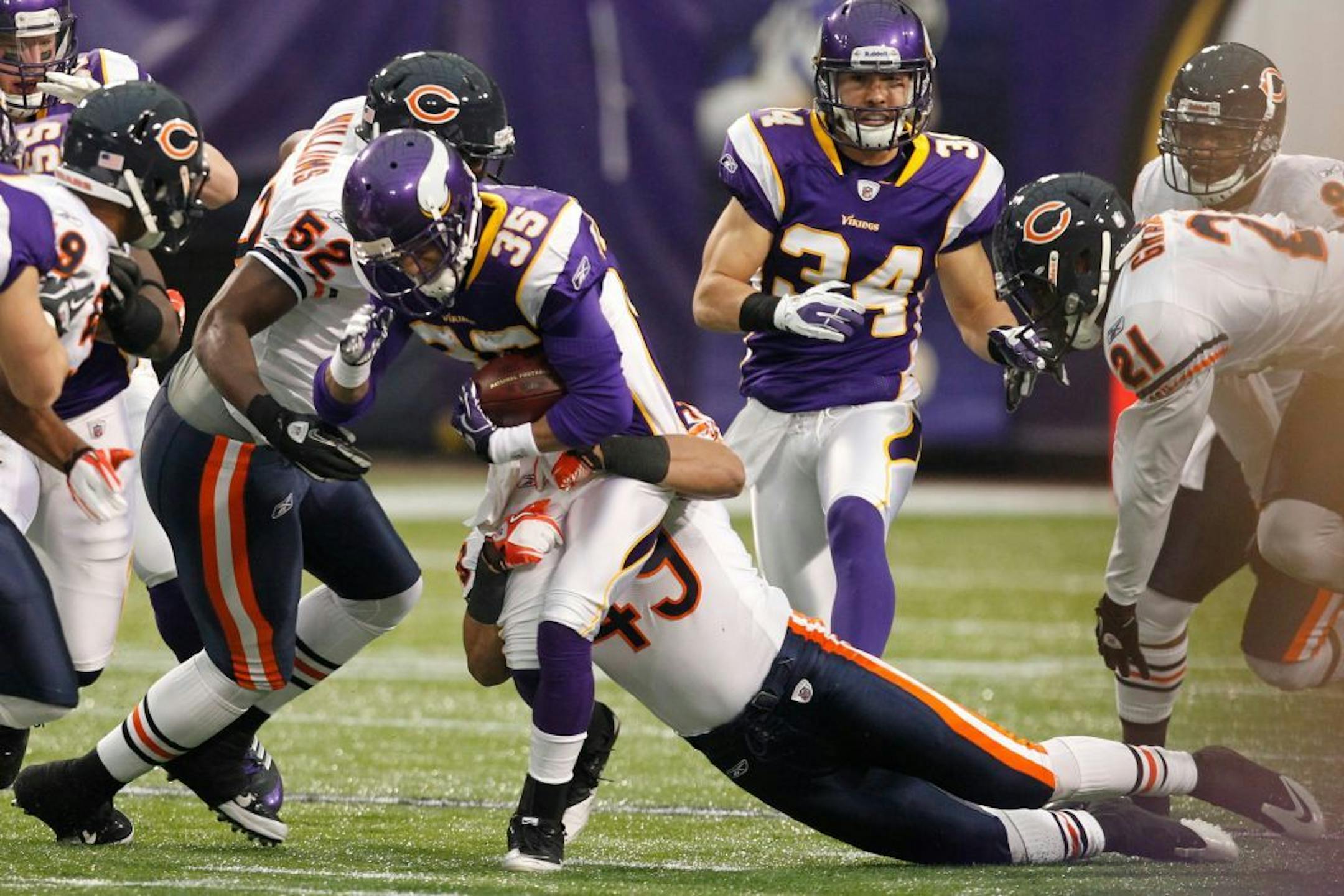 Minnesota Vikings cornerback Marcus Sherels (35) gets tackled by Chicago Bears strong safety Winston Venable (49) on a kickoff return in the first half of an NFL football game in Minneapolis, Sunday, Jan. 1, 2012.