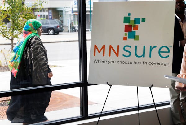 In this Oct. 26, 2017, photo, a woman walked past the Briva Health enrollment office for MNsure, Minnesota’s insurance marketplace, in Minneapolis.