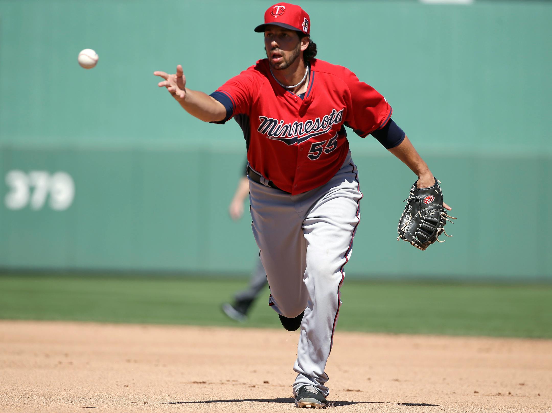 Minnesota Twins first baseman Chris Colabello throws to first to retire Boston Red Sox's David Ross in the third inning of an exhibition baseball game Friday, Feb. 28, 2014, in Fort Myers, Fla. The Twins won 8-2 over the Red Sox. (AP Photo/Steven Senne)