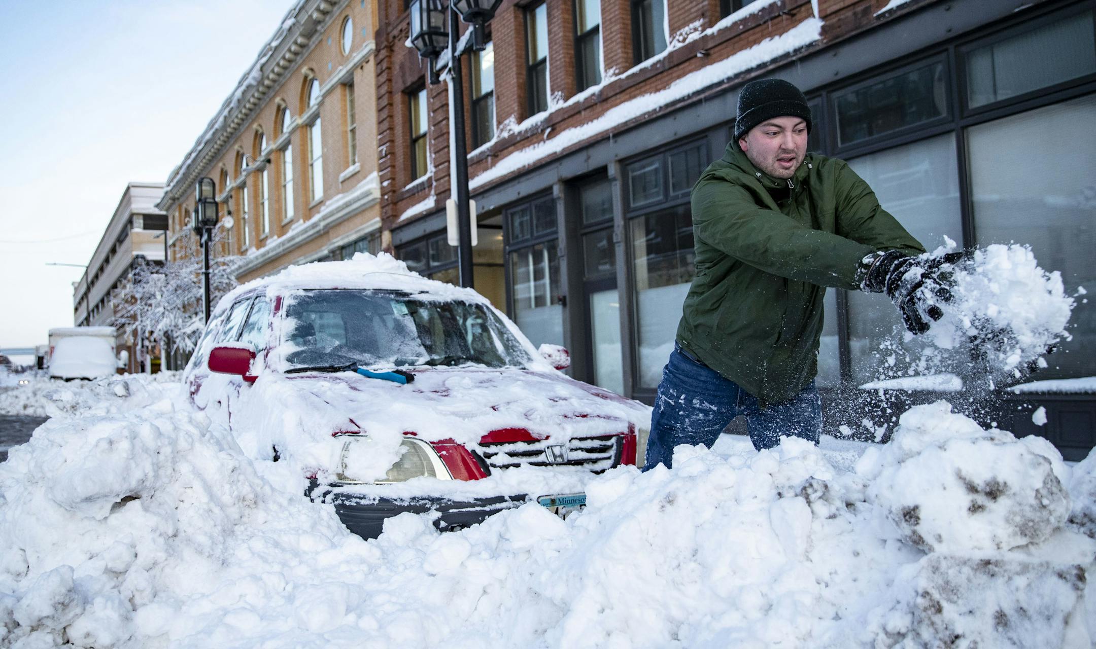 Alex Stock attempted to dig his car out of a snowbank by hand on First St. in Duluth, MN on Sunday afternoon. He eventually freed his car. ]
ALEX KORMANN • alex.kormann@startribune.com A "historic" storm has hit Duluth, pounding it with gale force winds and two feet of snow over the weekend.