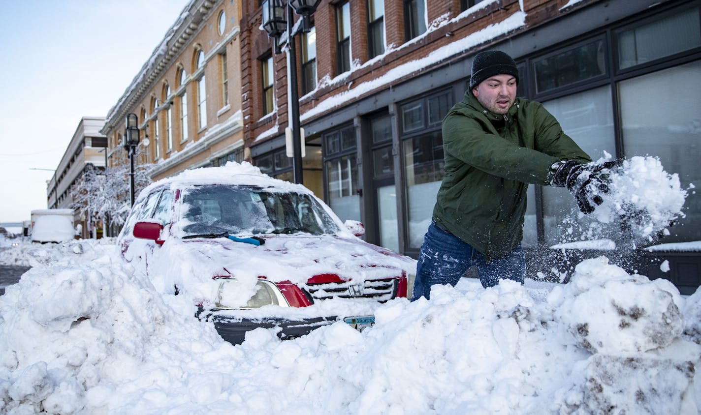 Alex Stock attempted to dig his car out of a snowbank by hand on First St. in Duluth, MN on Sunday afternoon. He eventually freed his car. ]
ALEX KORMANN &#x2022; alex.kormann@startribune.com A "historic" storm has hit Duluth, pounding it with gale force winds and two feet of snow over the weekend.