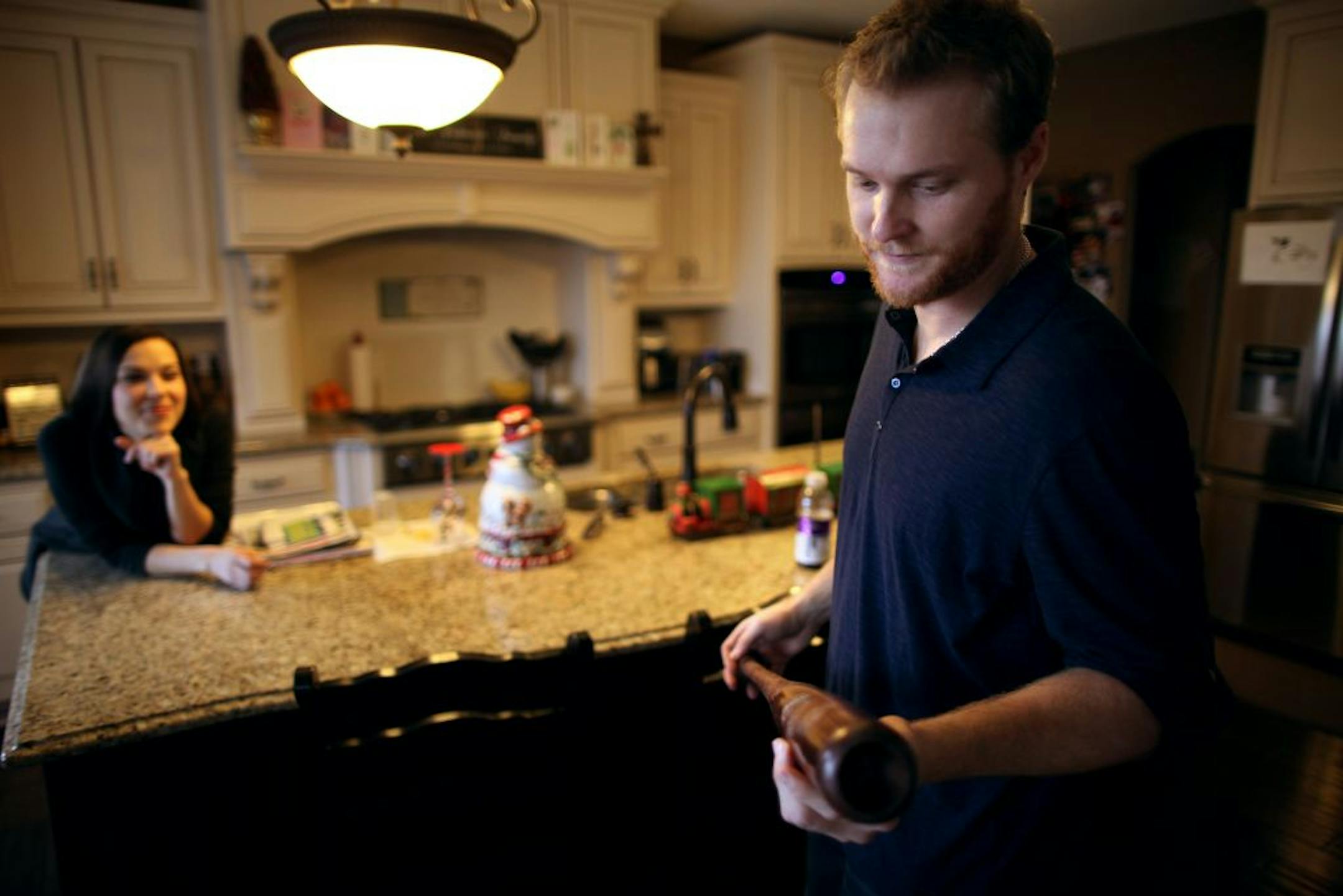 Dan Johnson looked for the scuff on the bat he used last Sept. 28 to help Tampa Bay win an improbable comeback against the New York Yankees on the final day of the season and advance to a divisional series. His wife, Holly, left, was watching at their Ham Lake home. After saving Tampa Bay's season, the Rays released him in November and Johnson, 32, is still hoping to catch on with a team even as he builds his second career.