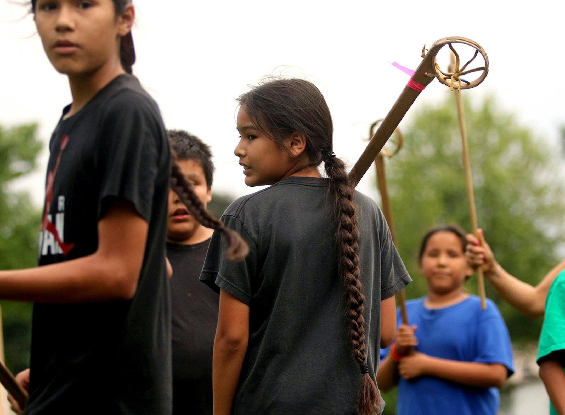 Youth boys team members of Twin Cities Native Lacrosse and brothers Bronson Grant, left, Quinlan Grant, middle, during practice at Corcoran Park Wednesday, June 17, 2015, in Minneapolis, MN. The traditional Lacrosse players, who play with hand carved ash sticks, were preparing for the upcoming Twin Cities Native Lacrosse Tournament at the Osseo High School Saturday.