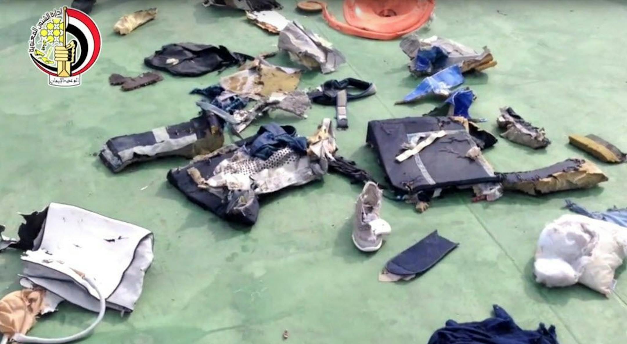FILE - This file still image taken from video posted Saturday, May 21, 2016, on the official Facebook page of the Egyptian Armed Forces spokesman shows some personal belongings and other wreckage from EgyptAir flight 804 in Egypt. Human remains retrieved from the crash site of EgyptAir Flight 804 suggest there was an explosion on board that may have brought down the aircraft in the east Mediterranean, a senior Egyptian forensics official said on Tuesday, May 24, 2016.