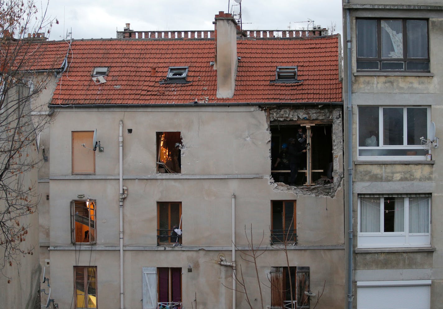 The building of Wednesday's raid on an apartment is pictured in Paris suburb Saint-Denis, Thursday Nov.19, 2015. Abdelhamid Abaaoud, the Belgian extremist suspected of masterminding the deadly attacks in Paris died a day ago along with his female cousin in a police raid on a suburban apartment building. (AP Photo/Christophe Ena)