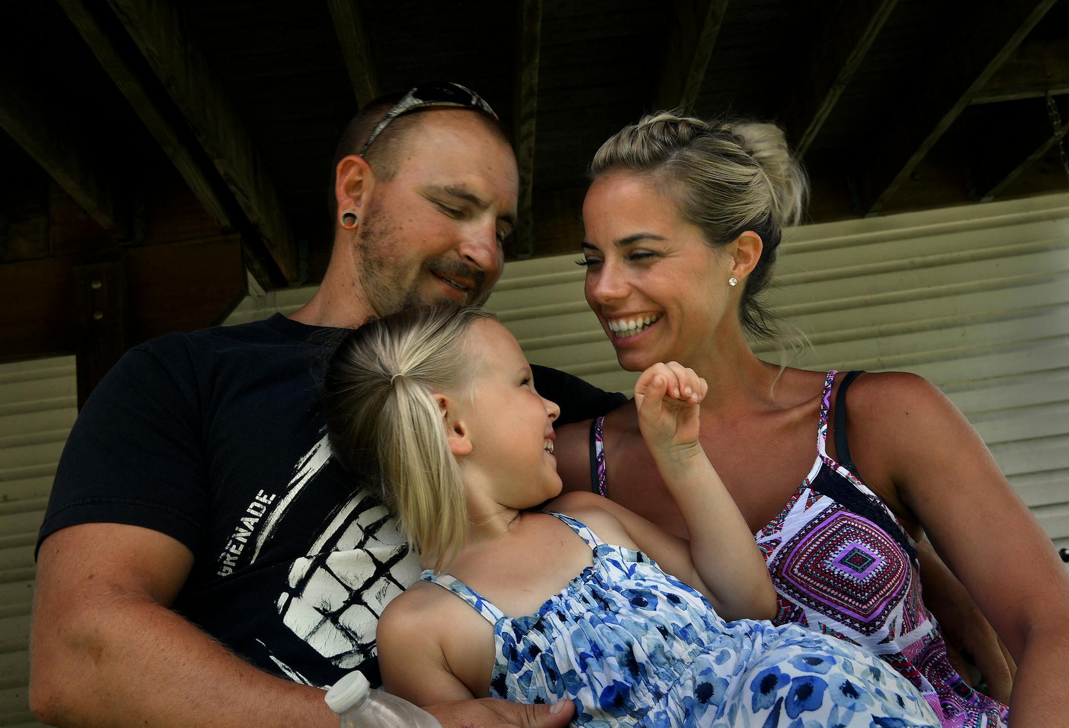 Lauren Conner, who was feared dead after falling from a boat Sunday, laughs with her boyfriend, Scott Johnson, and his 3-year-old daughter, Juliet.