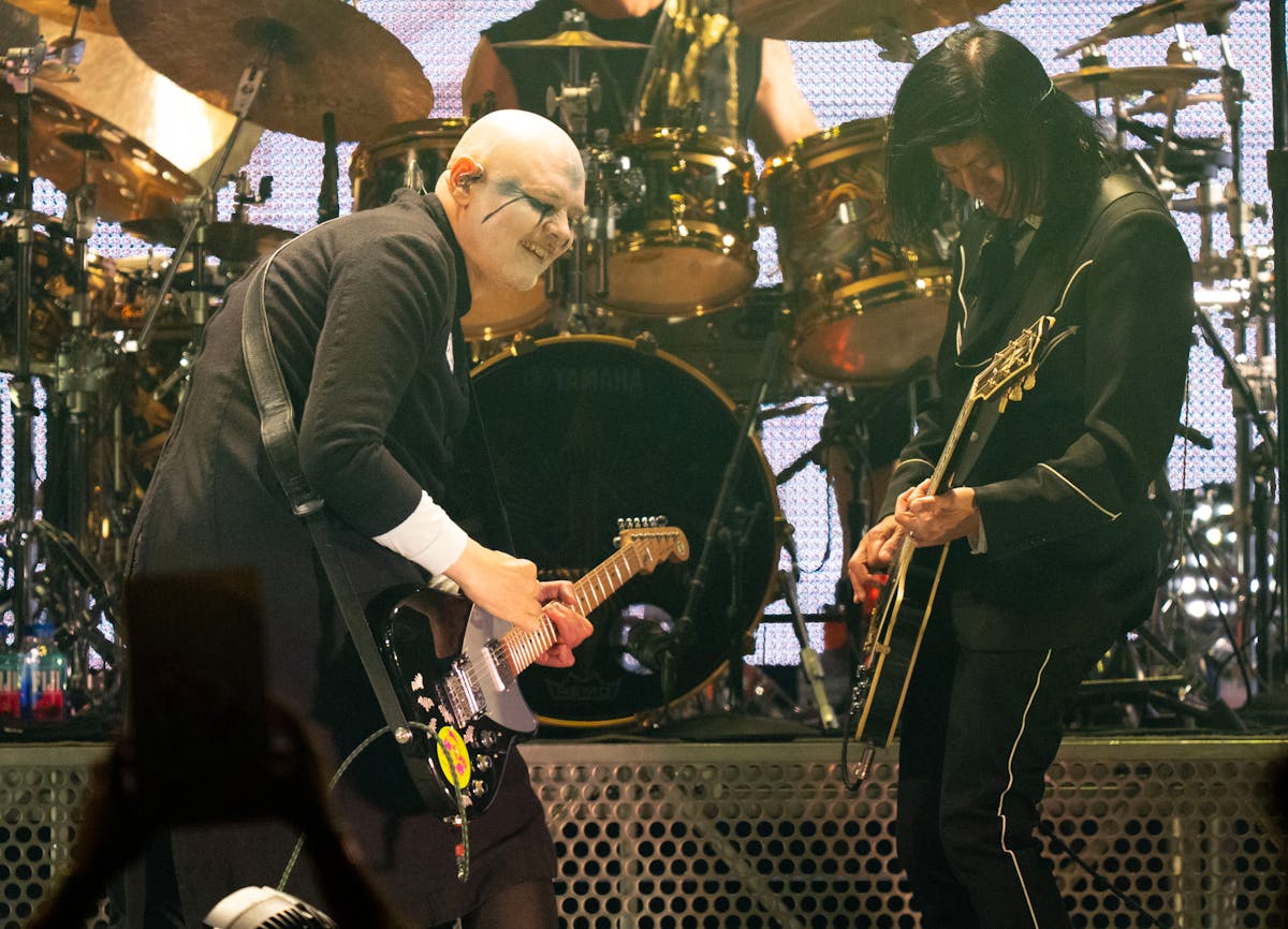 Billy Corgan and James Iha, left to right, the lead singer and guitarist of The Smashing Pumpkins, respectively, play guitar with each other during th