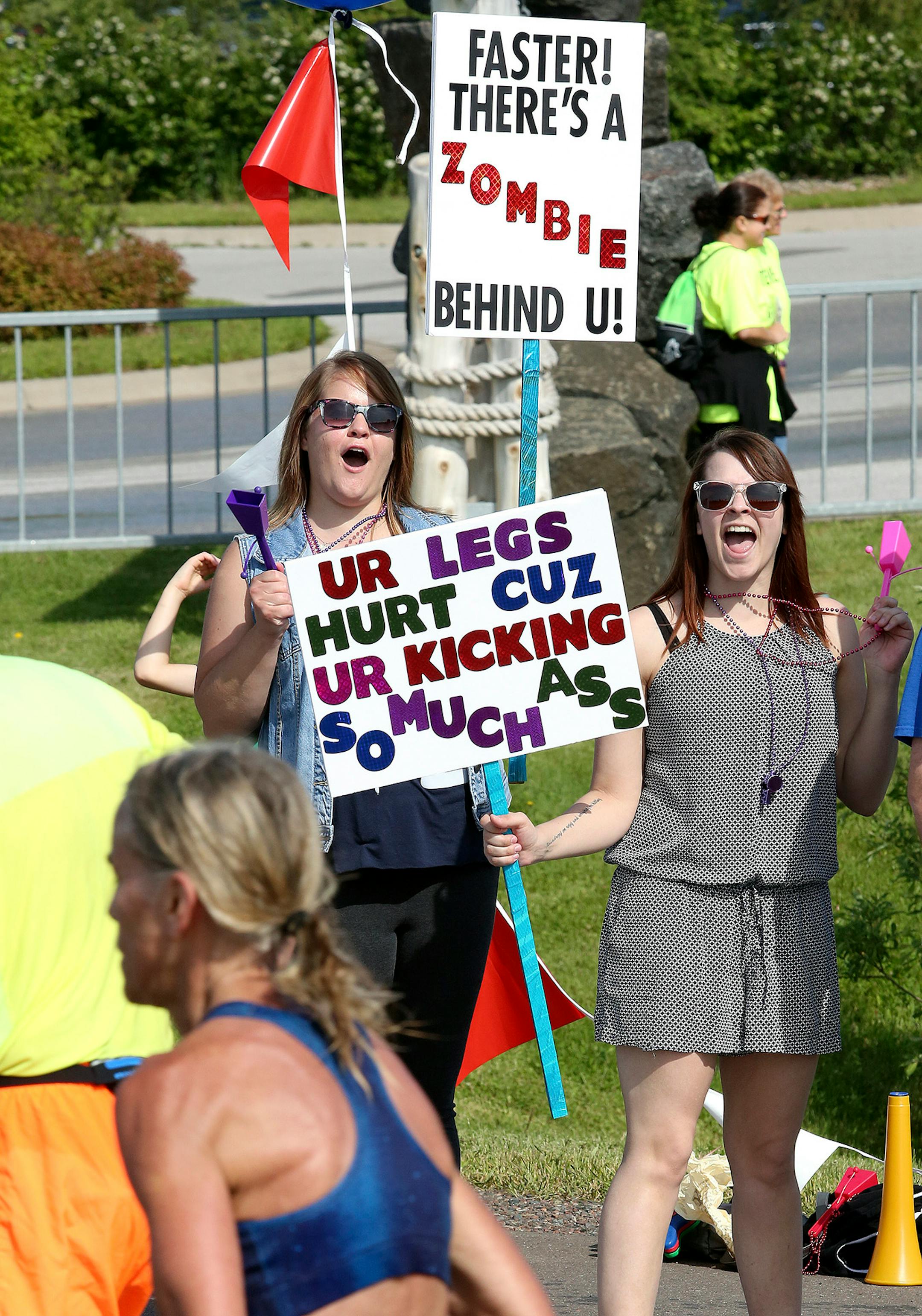 Beth Dahl (left) and Emily Carlson encourage Grandma�s Marathon racers passing near McQuade Road on Saturday.