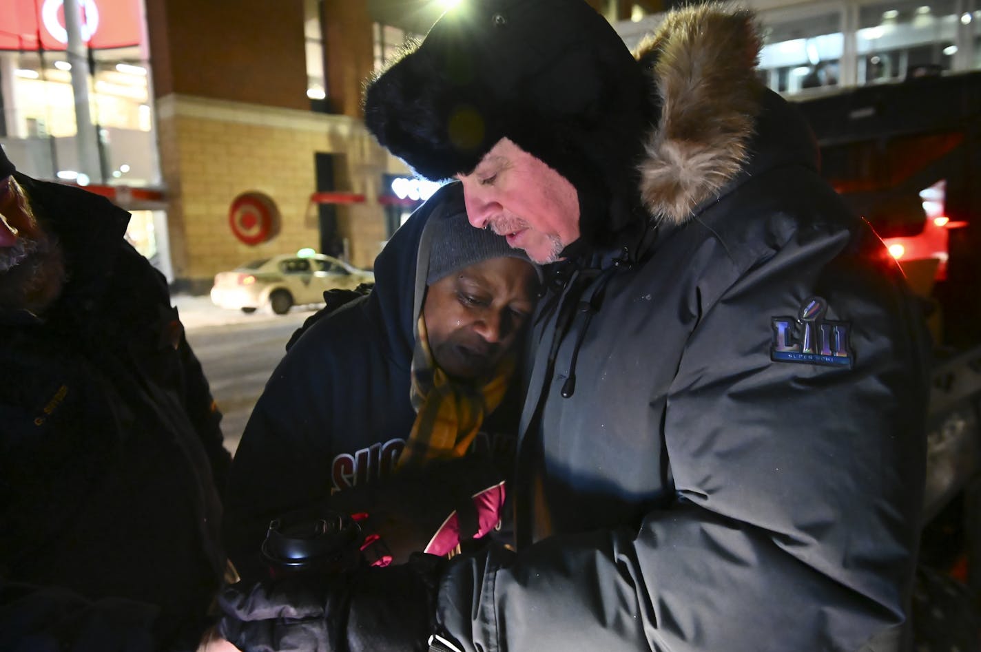 Pastor John Steger, with Grace In The City, embraced a homeless woman in downtown Minneapolis on Tuesday night.