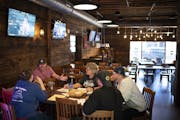 Daniel Hull, second from left, met with his managers Oct. 7 at the Nutty Squirrel Sports Saloon in River Falls, Wis.