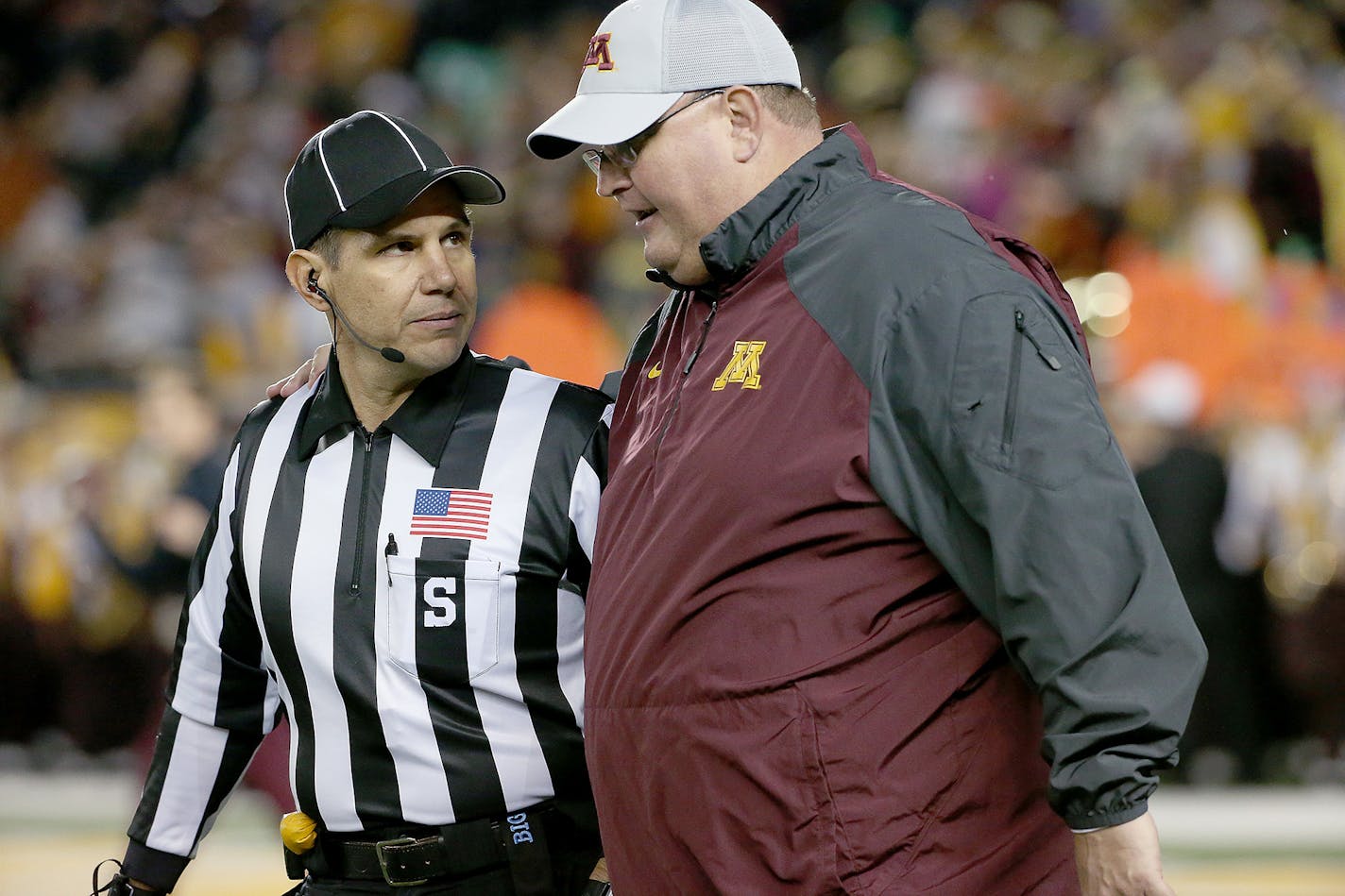 Minnesota's interim head coach Tracy Claeys walked onto the field with a referee before Minnesota took on Michigan at TCF Bank Stadium, Saturday, October 31, 2015 in Minneapolis.