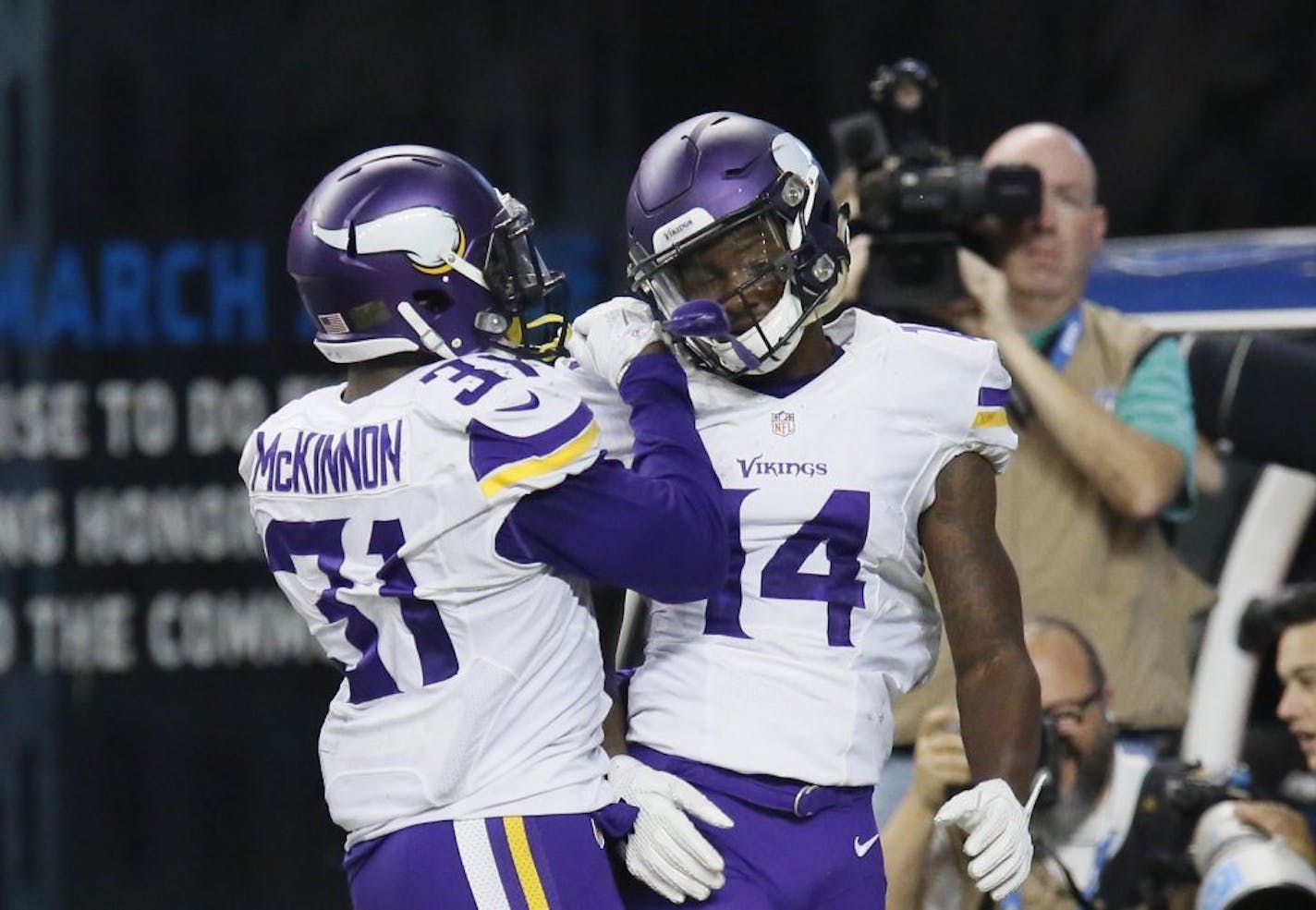 Minnesota Vikings wide receiver Stefon Diggs (14) is congratulated by teammate Jerick McKinnon (31) after scoring on a 36-yard reception for a touchdown during the second half of an NFL football game against the Detroit Lions, Sunday, Oct. 25, 2015, in Detroit.