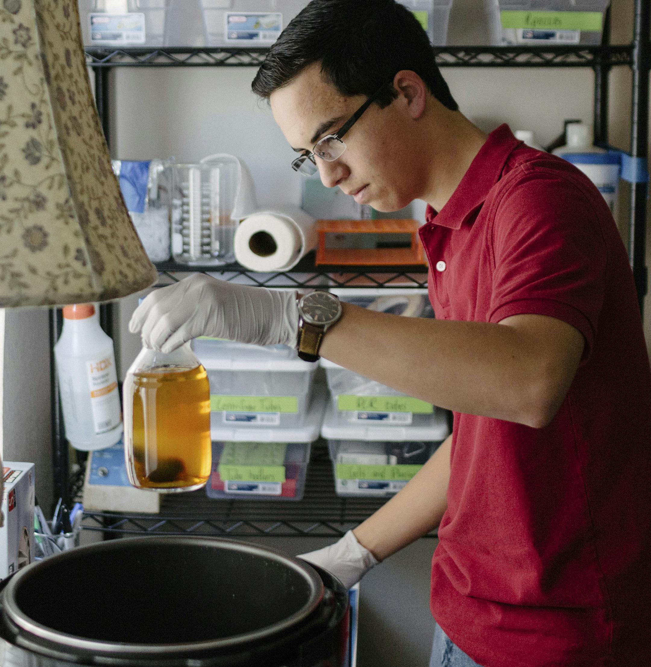 Keoni Gandall moves a pressure cooker he uses to sterilize equipment in his home laboratory, where he conducts biohacker genetic research, in Palo Alto, Calif., Feb. 14, 2018. In the past few years, so-called biohackers across the country have taken gene editing into their own hands. “I just wanted to clone DNA using my automated lab robot and feasibly make full genomes at home,” he said. (Erin Brethauer/The New York Times)