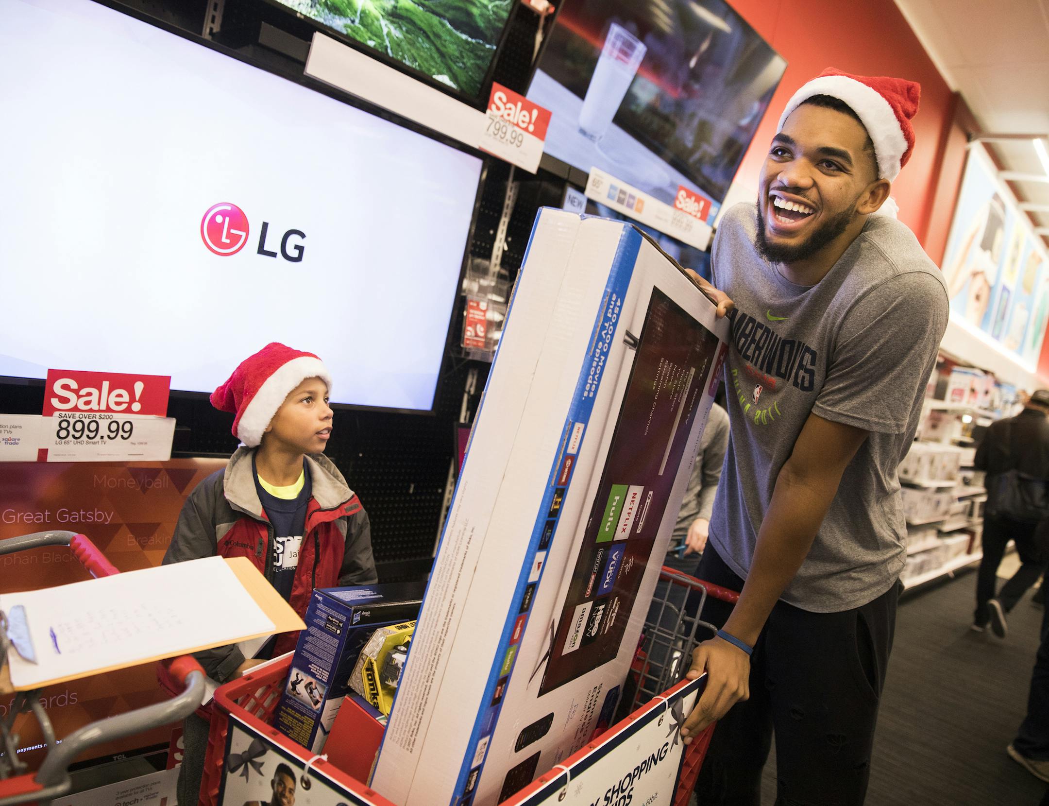 Timberwolves player Karl-Anthony Towns shops with Jaidon Jackson, 8, of Rosemount, whose father is in the Minnesota Army National Guard. ] LEILA NAVIDI ï leila.navidi@startribune.com BACKGROUND INFORMATION: Holiday shopping with Timberwolves players at Target in downtown Minneapolis on Friday, December 8, 2017. The Minnesota Timberwolves FastBreak Foundation in partnership with United Heroes League hosted 15 children from low-income households, that currently have or recently had a parent i