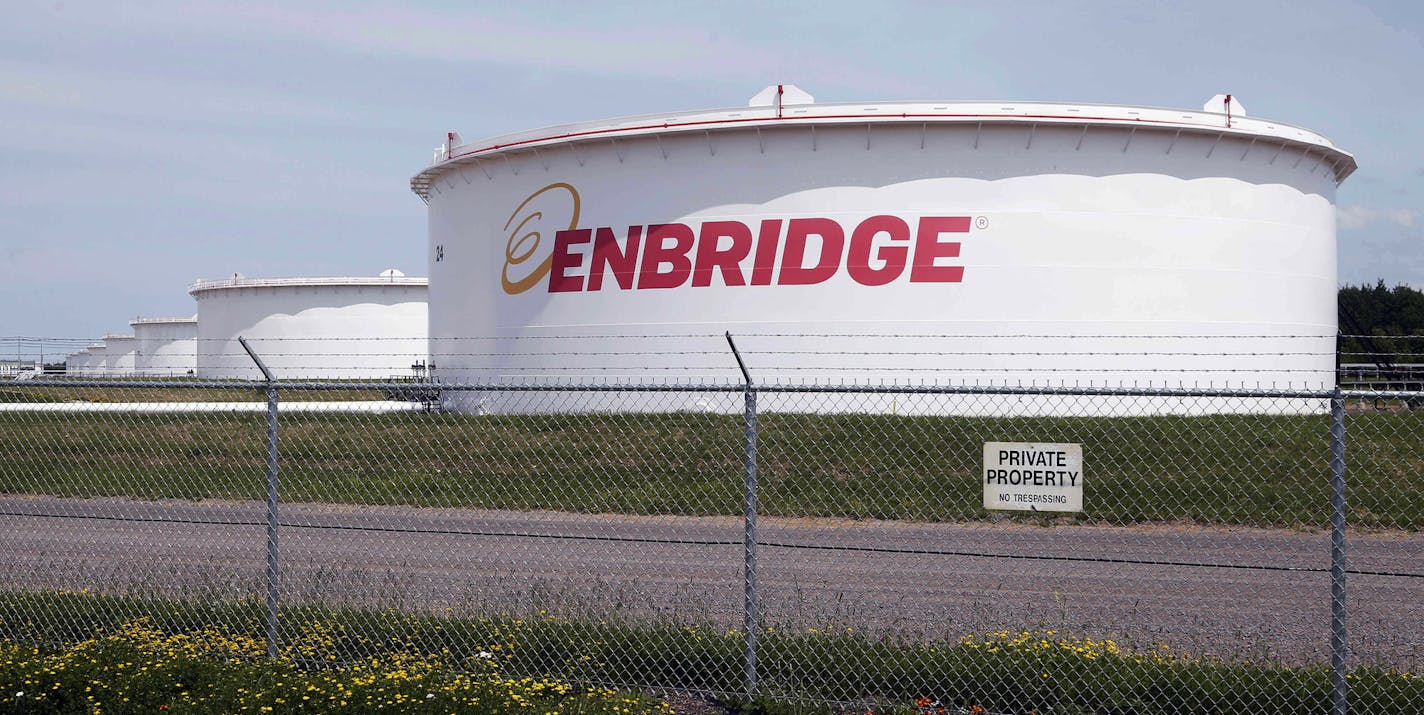 FILE - This June 29, 2018 photo shows tanks at the Enbridge Energy terminal in Superior, Wis. Enbridge Energy is delaying the startup of its planned Line 3 replacement crude oil pipeline through northern Minnesota by a year. The Canadian-based company now expects the new pipeline to go into service in the second half of 2020. Enbridge officials had hoped to put the pipeline into service in the second half of 2019. But Minnesota Gov. Tim Walz has said his administration will keep pursuing an appe