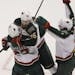 Minnesota Wild left wing Pierre-Marc Bouchard, center, celebrates after his open-net goal with right wing Cal Clutterbuck, left, and center Matt Culle