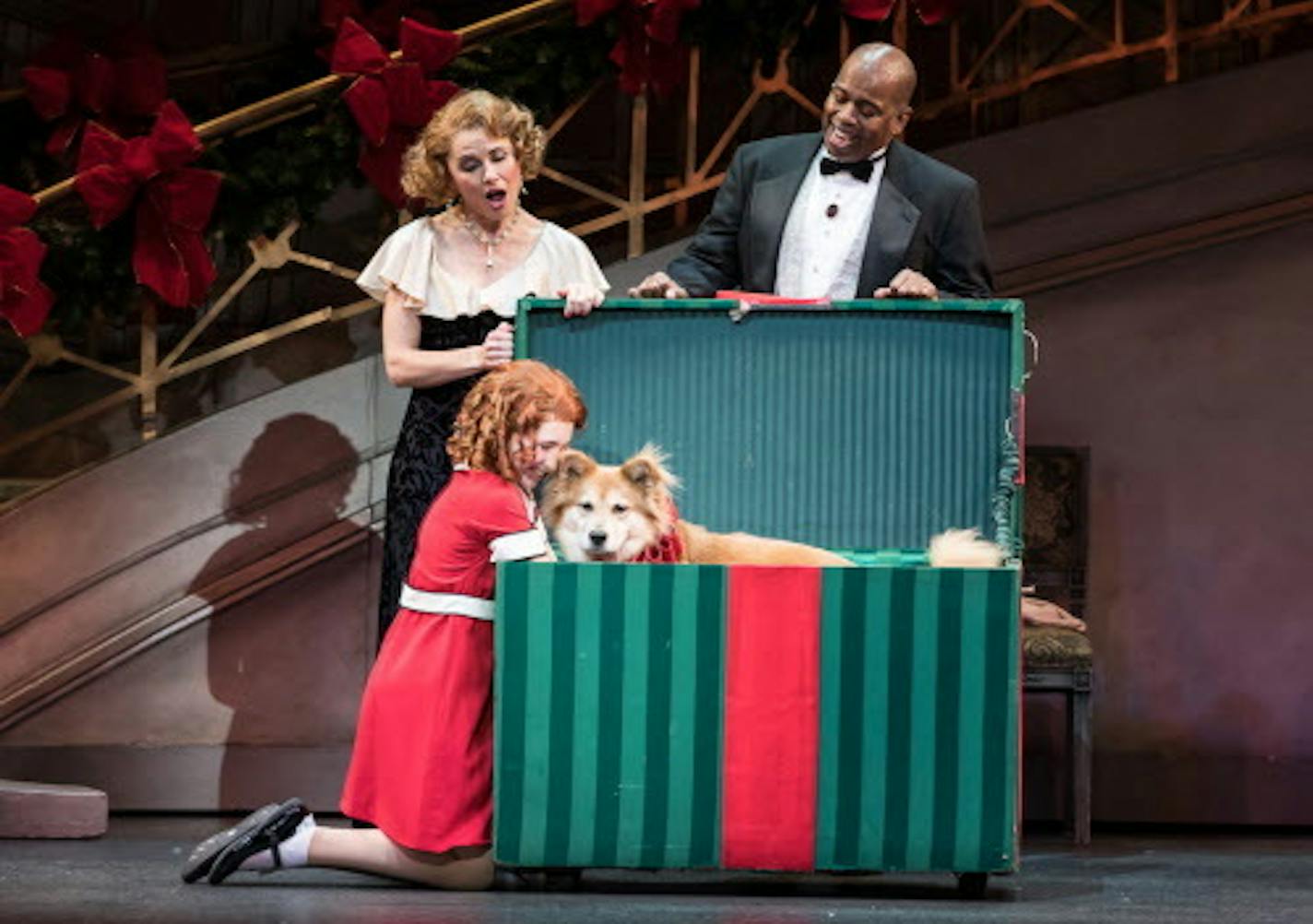 Ann Michels as Grace Ferrell, Lance Roberts as Oliver Warbucks, and Carly Gendell as Annie in "Annie" at the Ordway.