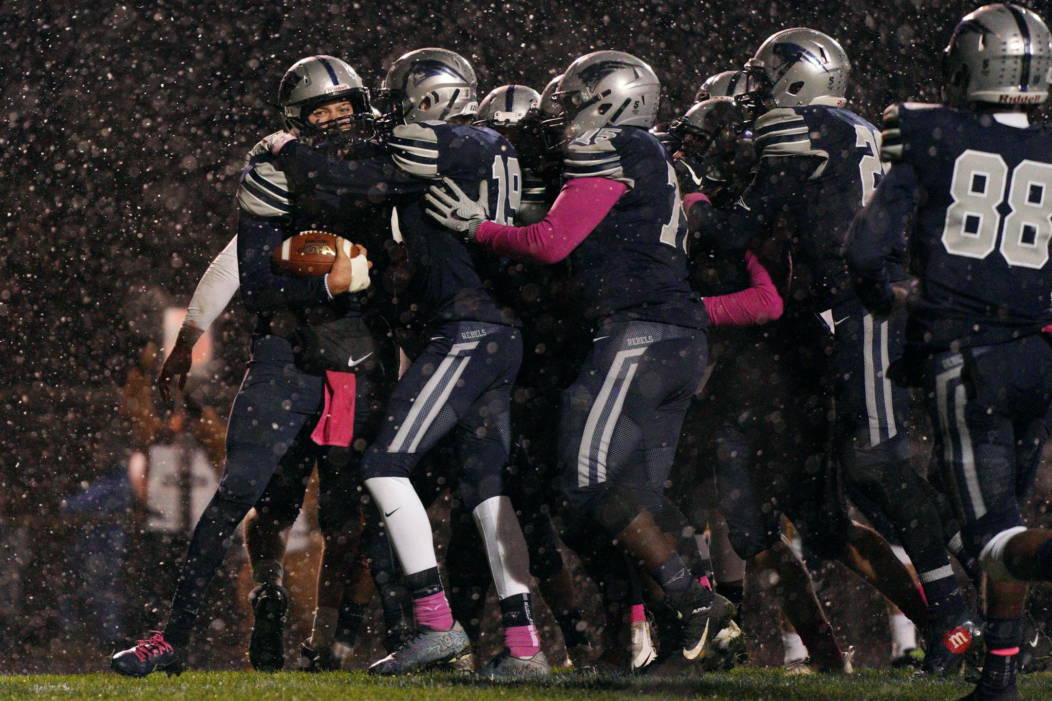 Champlin Park quarterback Jaice Miller (4) was mobbed by his teammates in the end zone after he scored a touchdown in the second half. ] ANTHONY SOUFFLE • anthony.souffle@startribune.com Champlin Park played Totino-Grace in an MSHSL football game Friday, Oct. 11, 2019 at Champlin Park High School in Champlin, Minn.