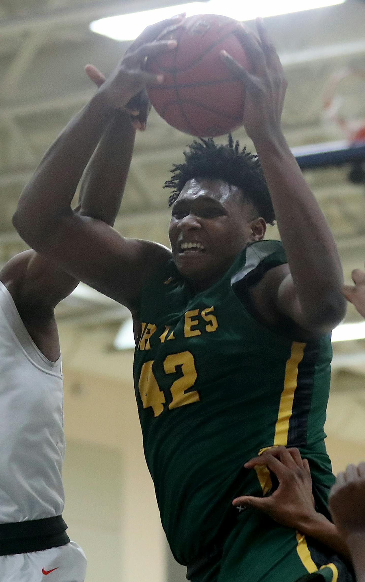 Park Center's Dain Dainja (42) is fouled by Osseo's Chike Okonkwo (25) during the first half of the boys' basketball Class 4A, Section 5 championship at Rogers High, in Rogers, MN.] DAVID JOLES &#xef; david.joles@startribune.com boys' basketball Class 4A, Section 5 championship, Park Center vs. Osseo at Rogers High, in Rogers, MN.