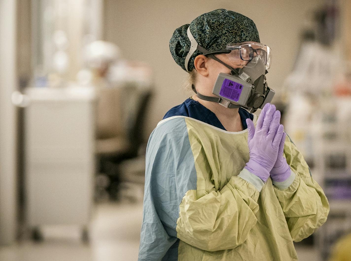 Amanda Regan, RN, paused for a moment during her shift with COVID-19 patients in the ICU at Mercy Hospital in Coon Rapids.