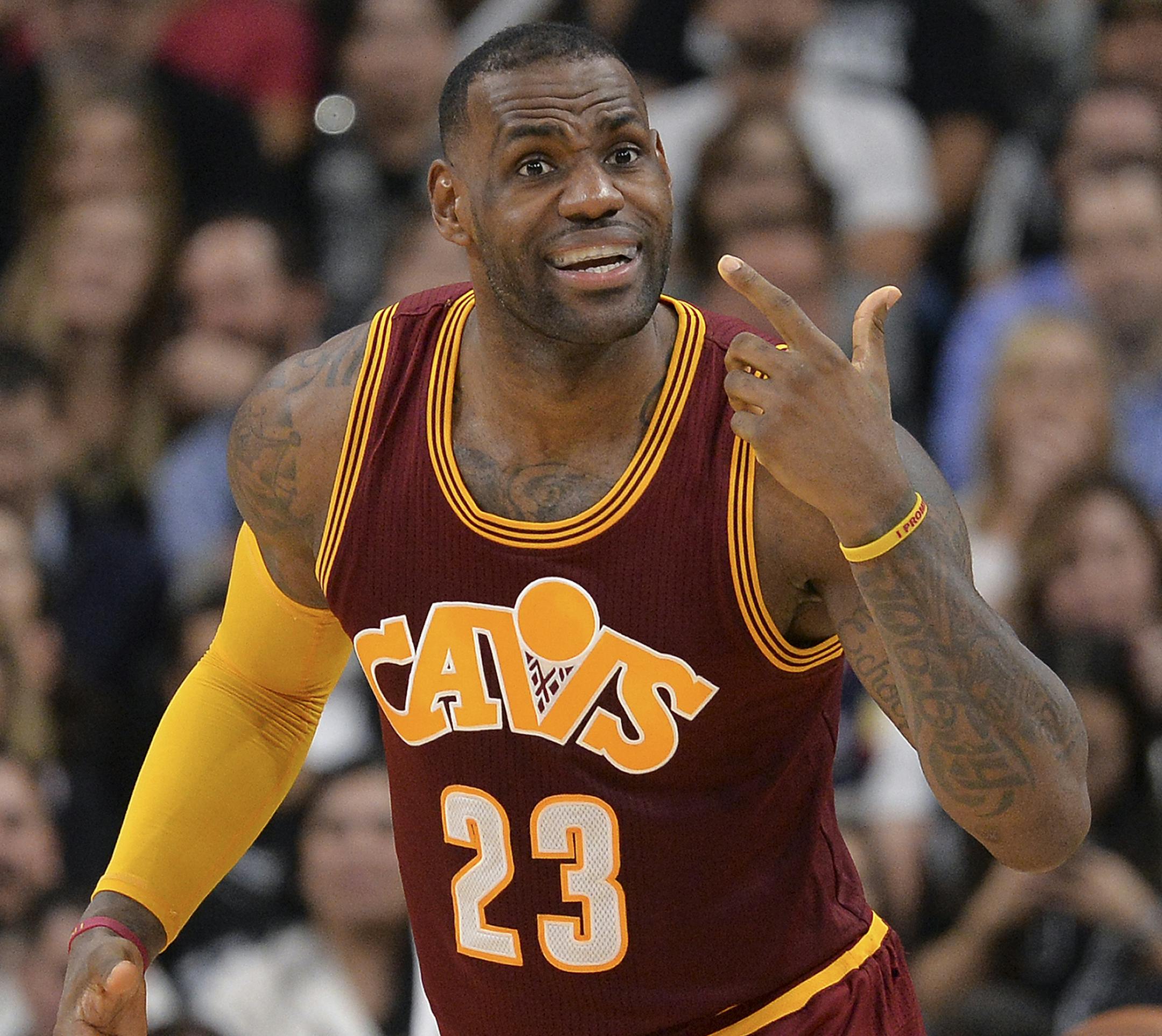 Cleveland Cavaliers forward LeBron James gestures to the Cleveland bench during the second half of an NBA basketball game against the San Antonio Spurs, Thursday, Jan. 14, 2016, in San Antonio. San Antonio won 99-95. (AP Photo/Darren Abate)