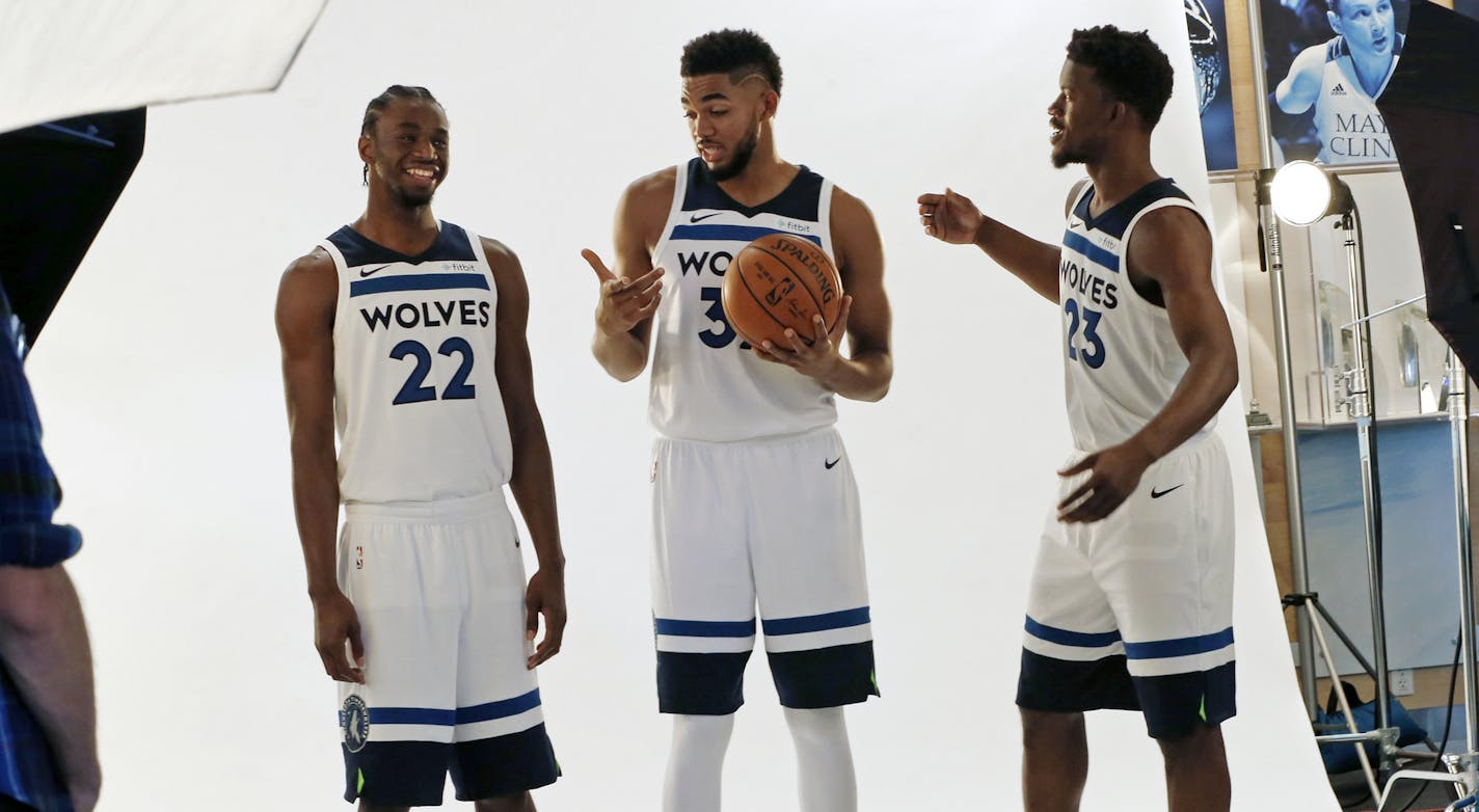 Minnesota Timberwolves' Andrew Wiggins, left, Karl-Anthony Towns, center and Jimmy Butler wait to pose during the NBA basketball team media day Friday, Sept. 22, 2017, in Minneapolis. (AP Photo/Jim Mone)