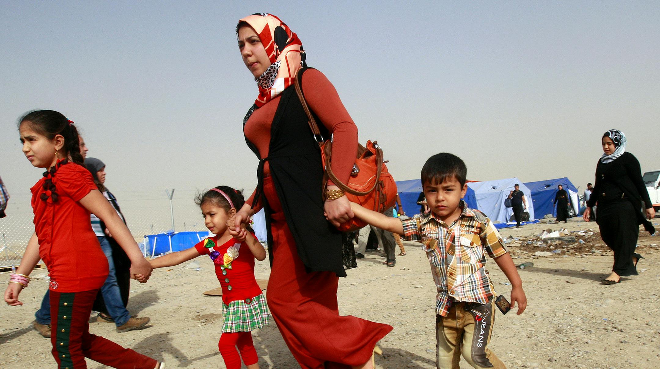 Refugees fleeing from Mosul head to the self-ruled northern Kurdish region in Irbil, Iraq, 350 kilometers (217 miles) north of Baghdad, Thursday, June 12, 2014. The Islamic State of Iraq and the Levant, the al-Qaida breakaway group, on Monday and Tuesday took over much of Mosul in Iraq and then swept into the city of Tikrit further south. An estimated half a million residents fled Mosul, the economically important city. (AP Photo) ORG XMIT: MIN2014061314082559