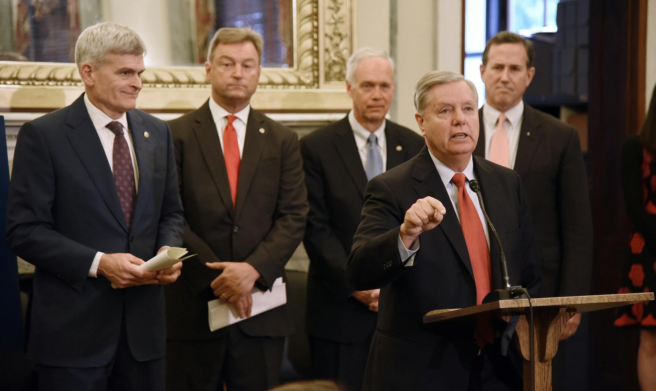 U.S. Sen. Lindsey Graham (R-S.C.) speaks as Sen. Bill Cassidy (R-La.), Sen. Dean Heller (R-Nev.), Sen. Ron Johnson (R-Wis.) listen during a news conference on health care on Wednesday, Sept. 13, 2017 on Capitol Hill in Washington, D.C. (Olivier Douliery/Abaca Press/TNS)