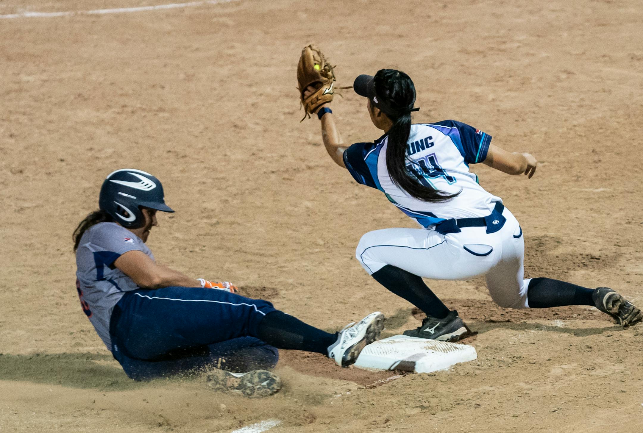 Aussie Peppers' Carmelle Sorenson (3) slide safely into third base against Canadian Wild's Janet Leung (14) in the seventh inning in North Mankato, Minn. Wednesday, July 3, 2019. ] RENEE JONES SCHNEIDER ¥ renee.jones@startribune.com