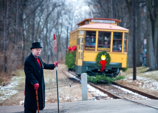 Bill Arends, playing the part of Ebenezer Scrooge stopped traffic at the Linden Hills Station so the Holly Trolly could pull safely into the station. Sunday, November 25, 2012. ] GLEN STUBBE * gstubbe@startribune.com
