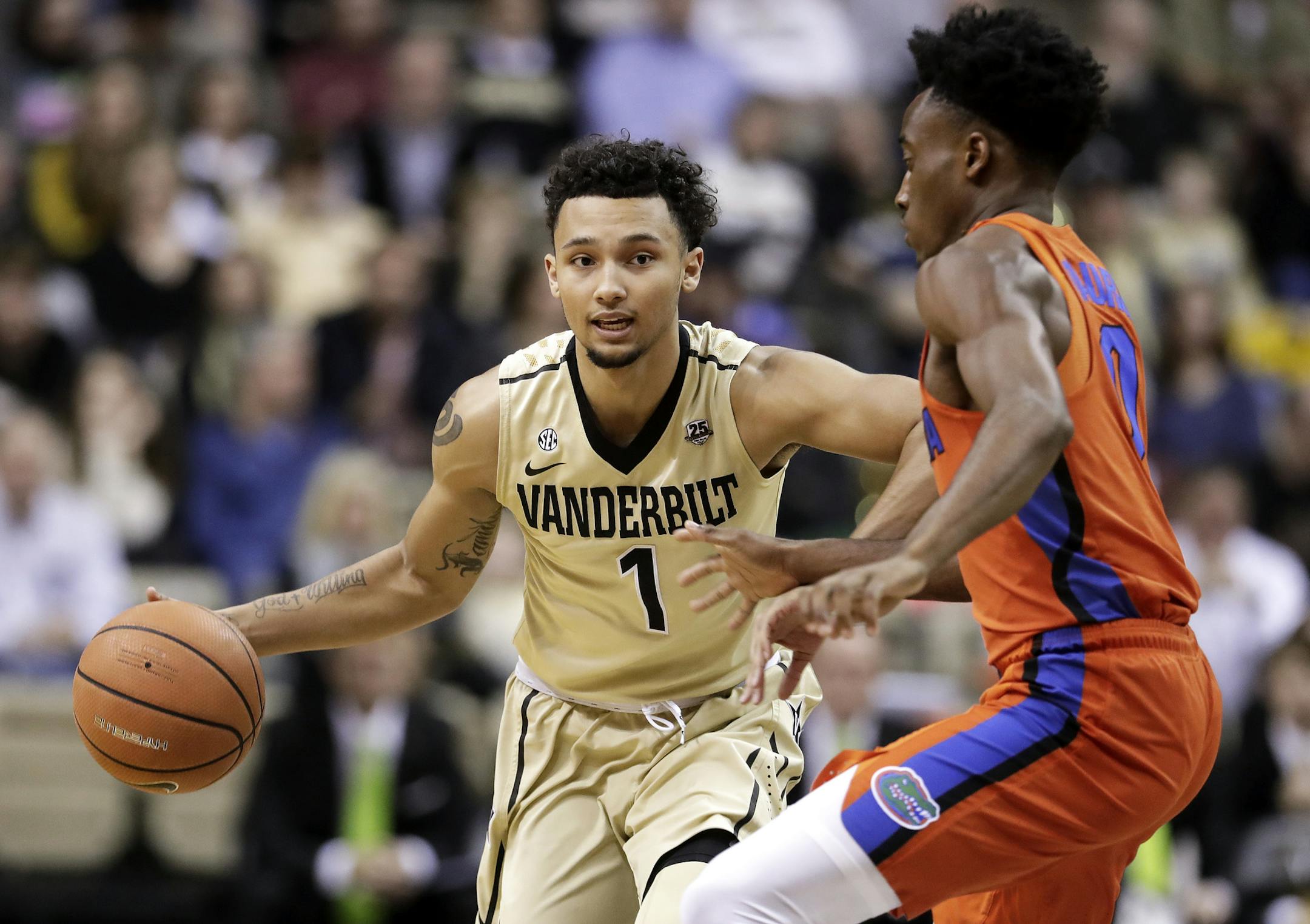 Vanderbilt guard Payton Willis (1) drives against Florida guard Mike Okauru, right, in the first half of an NCAA college basketball game Saturday, Feb. 17, 2018, in Nashville, Tenn. (AP Photo/Mark Humphrey) ORG XMIT: TNMH106
