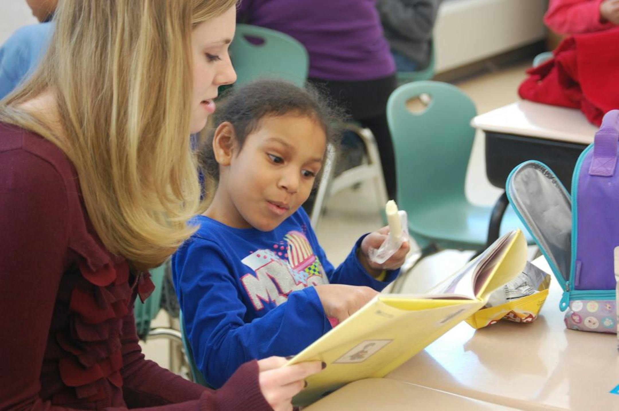 Miranda Dean ate her lunch while Audrey Anderson, a Honeywell employee, read to her as part of the Everybody Wins! literacy program at Forest Elementary in Crystal.