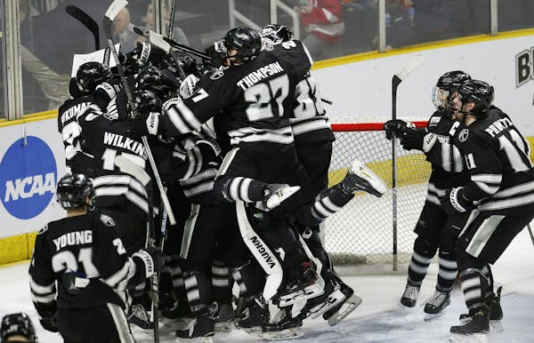 Providence players celebrate after defeating Cornell in the NCAA Division I East Regional final men's hockey game in Providence, R.I., Sunday, March 3