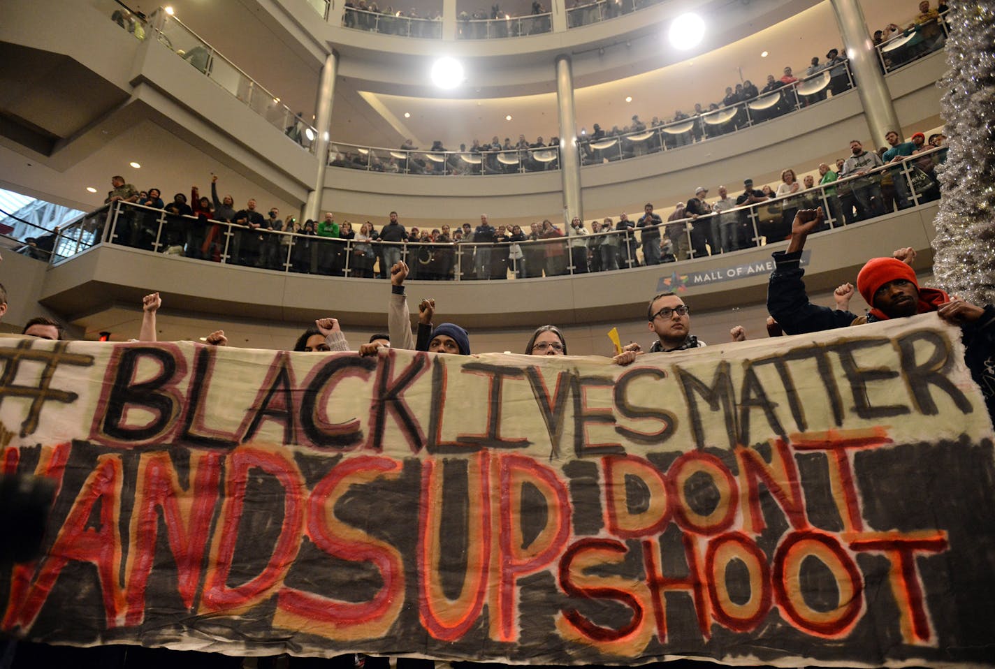 Demonstrators filled the Mall of America rotunda and chanted "Black lives matter" to protest police brutality, Saturday, Dec. 12, 2014, in Bloomington, Minn. The group Black Lives Matter Minneapolis had more than 3,000 people confirm on Facebook that they would attend. Attendance figures weren't immediately available. (AP Photo/The Star Tribune, Aaron Lavinsky) ORG XMIT: MIN2015011814105351 ORG XMIT: MIN1501181430293903