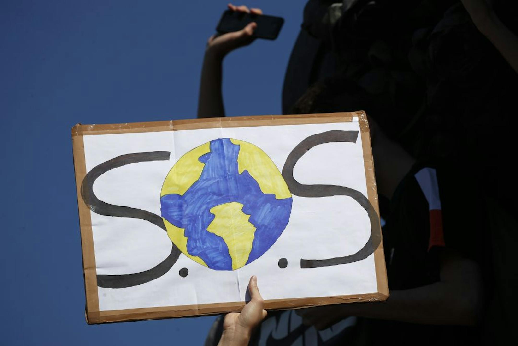 A protester shows a placard during a climate demonstration Friday, Sept. 20, 2019 in Paris. In Canberra and Kabul, Cape Town and Berlin, and across the globe, hundreds of thousands of people took the streets Friday to demand that leaders tackle climate change in the run-up to a U.N. summit.