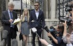 The parents of sick baby Charlie Gard, Connie Yates and Chris Gard, right, stand together as a statement is read by a family friend to the media, outs