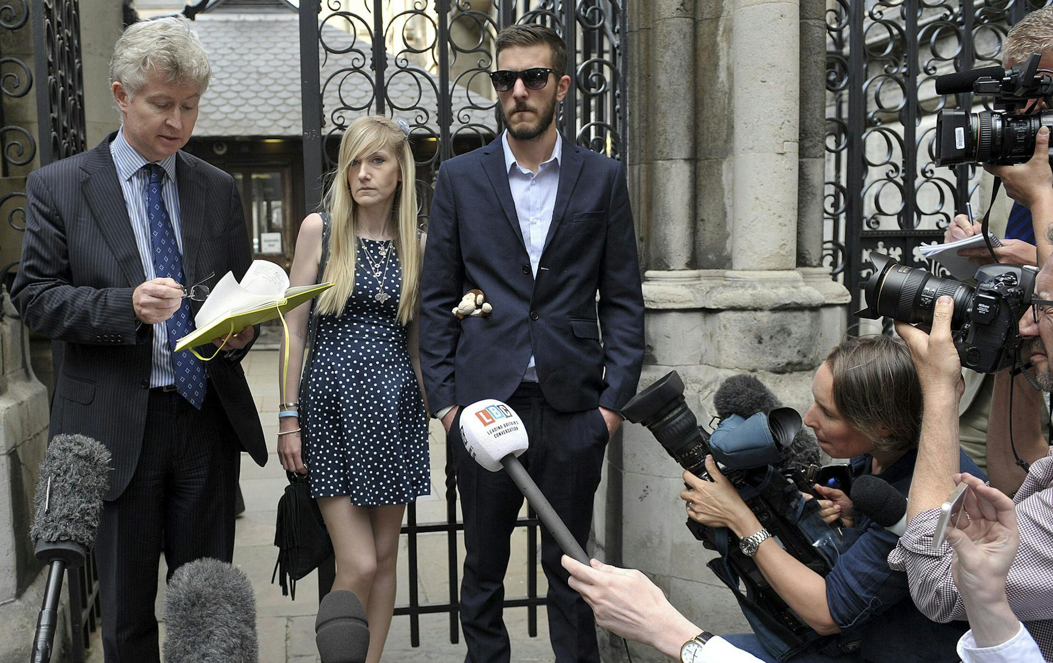 The parents of sick baby Charlie Gard, Connie Yates and Chris Gard, right, stand together as a statement is read by a family friend to the media, outside the High Court during an adjournment of their legal hearing to allow treated of their son with an experimental therapy, in London, Monday July 10, 2017. Charlie Gard is on life support at Great Ormond Street Hospital, and remains at the centre of a legal battle to allow the terminally ill infant to receive experimental treatment for his rare ge